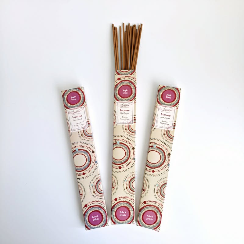 Three packs of incense sticks with decorative packaging on a white background