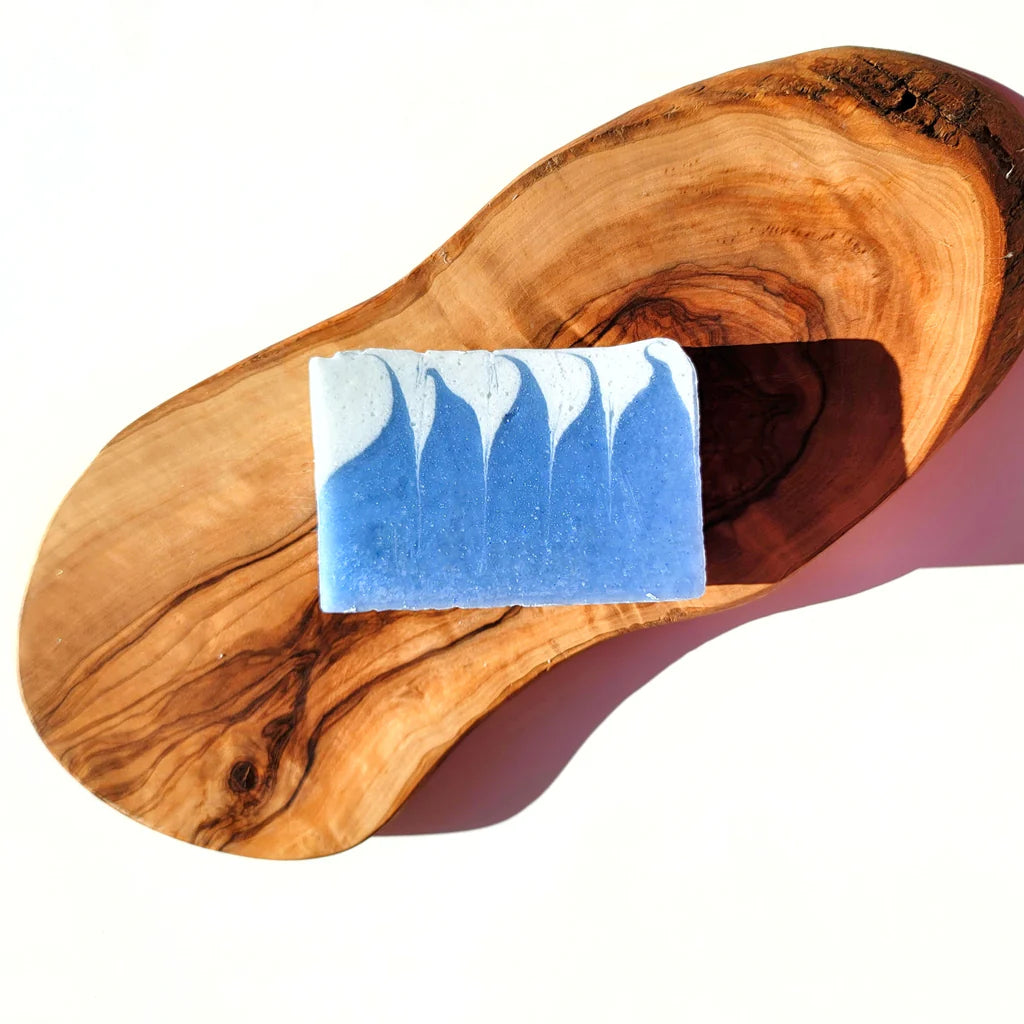 Blue soap bar on a wooden surface