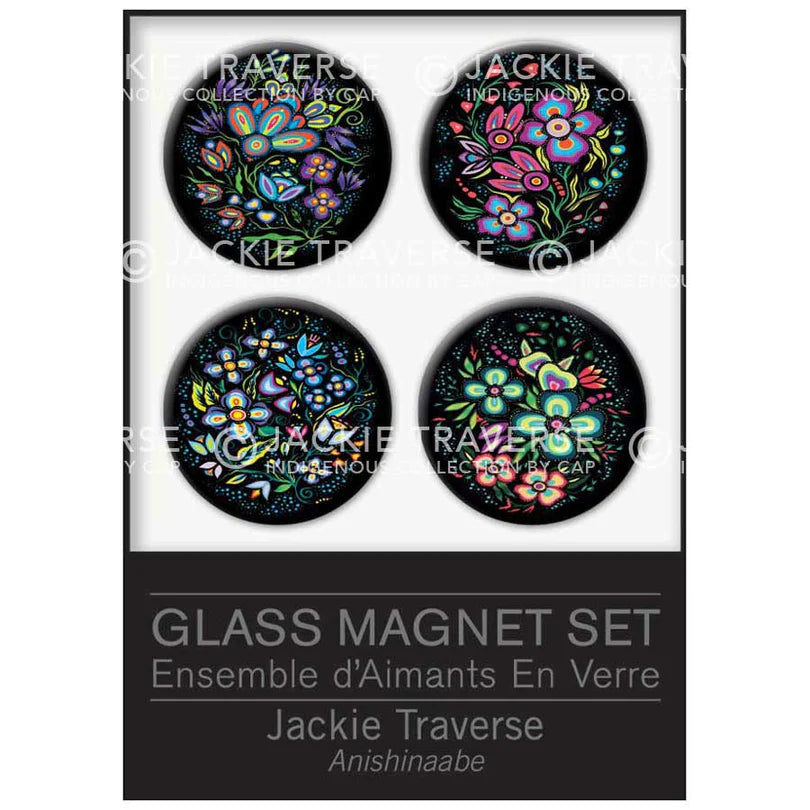 A boxed glass magnet set featuring four round black magnets with colorful floral and butterfly designs, shown against a white background with a black label area. The text reads 'GLASS MAGNET SET' and 'Jackie Traverse'.