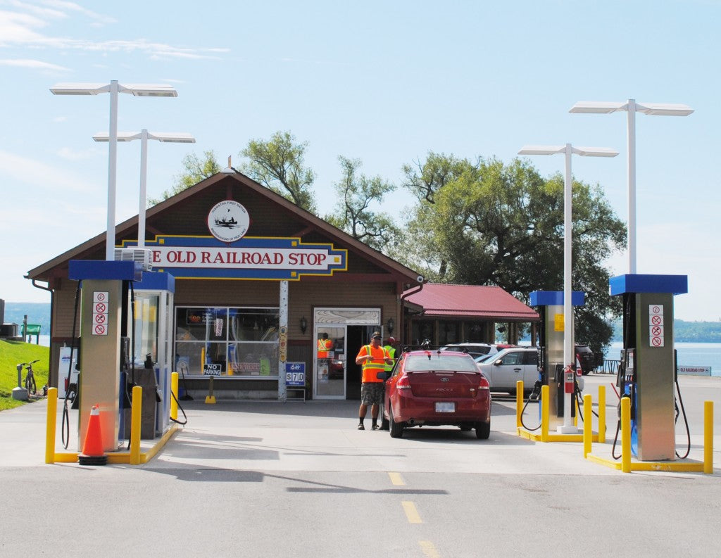 The Old Railroad Stop gas bar at 341 Hiawatha Line, pumps and lake