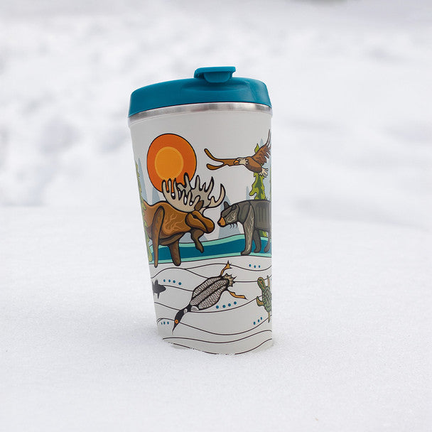 Travel mug with nature-themed design on a snowy background