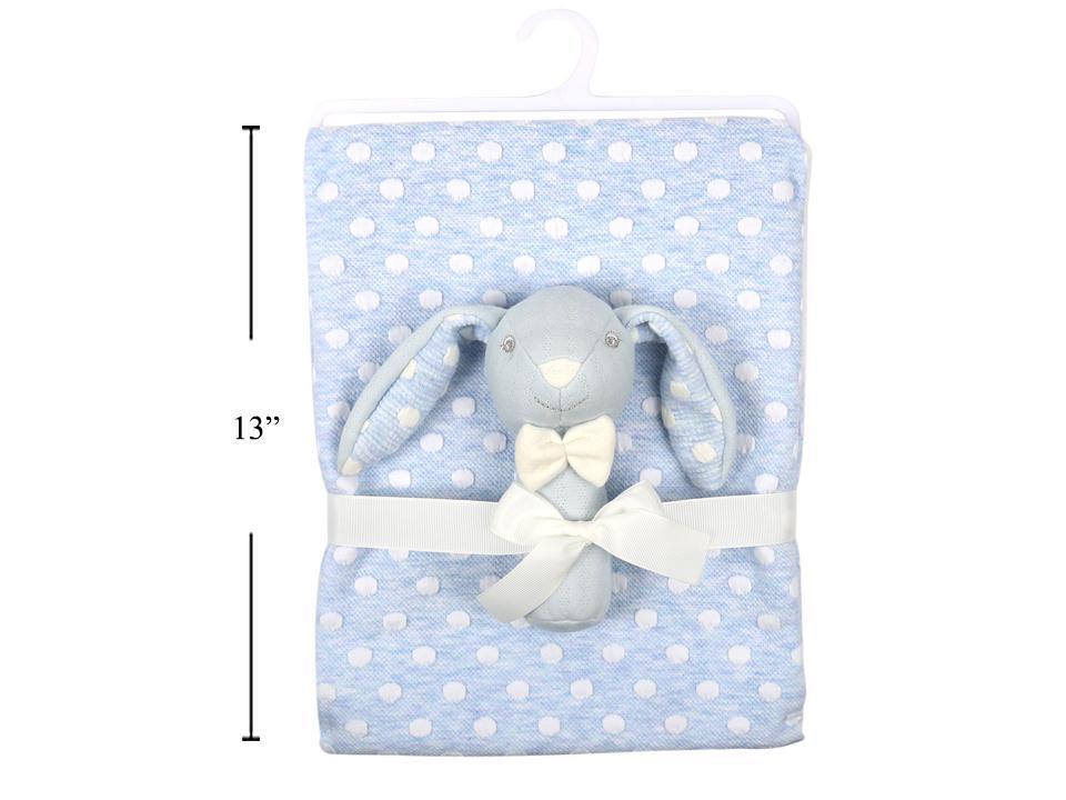 A folded baby blanket in light blue with white polka dots, wrapped with a white ribbon and featuring a plush gray bunny toy with a cream bow. A black vertical measurement line on the left indicates 13 inches.