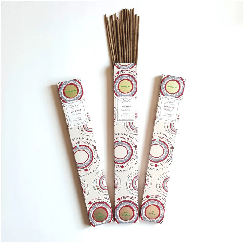 Three packs of incense sticks with decorative labels on a white background
