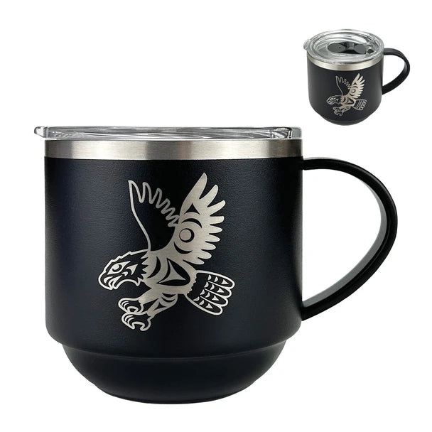 Black mug with a metallic eagle design on a white background