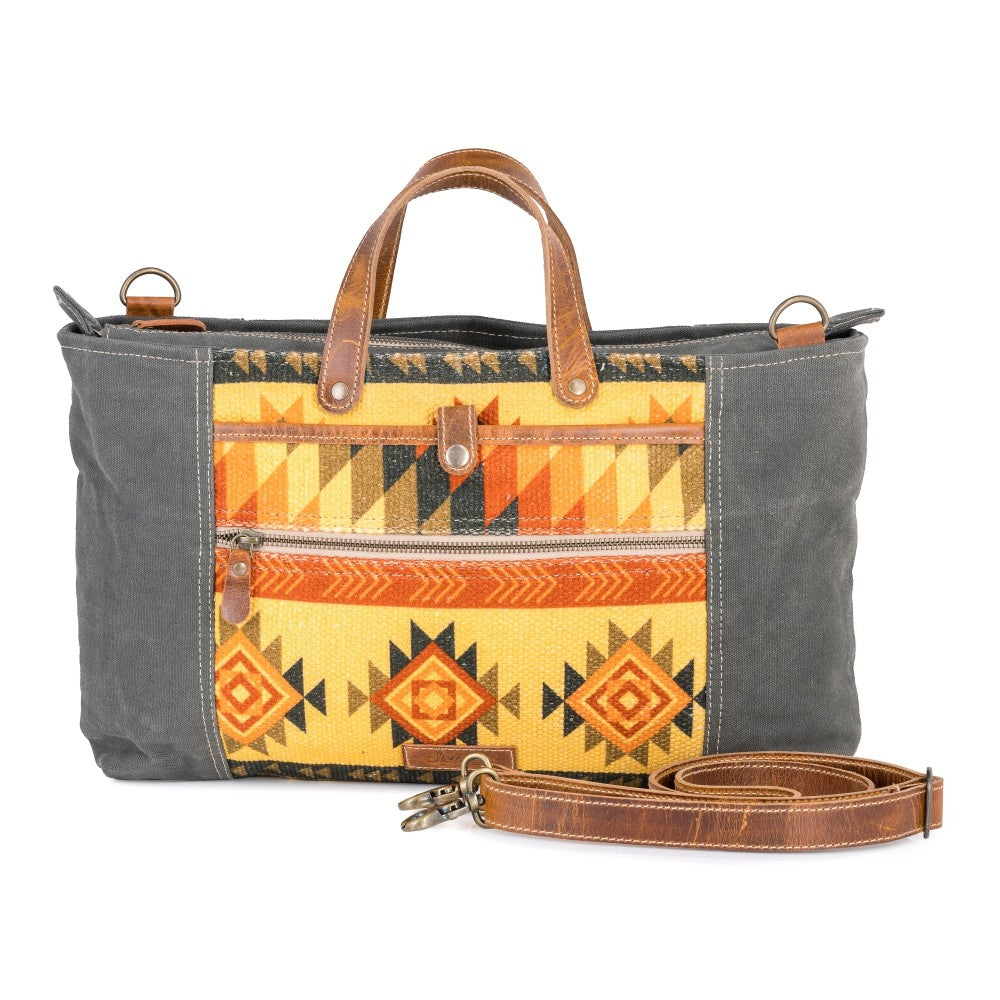 Gray bag with a yellow geometric pattern and brown leather accents on a white background