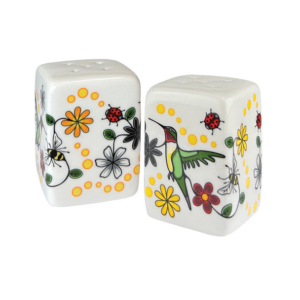 Two ceramic salt and pepper shakers with floral and insect designs on a white background