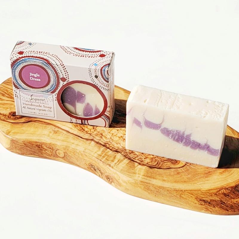 Bar of soap with a decorative box on a wooden surface