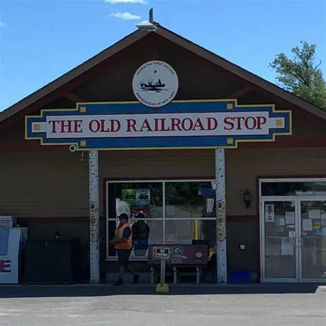 Building with 'The Old Railroad Stop' sign on a clear day
