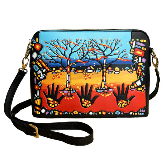 A rectangular black leather shoulder bag with a colorful hand-painted style design featuring three leafless trees, a blue sky, a yellow-to-red ground, and black hand silhouettes. The bag has a black adjustable shoulder strap with gold-tone hardware and is shown on a plain white background.