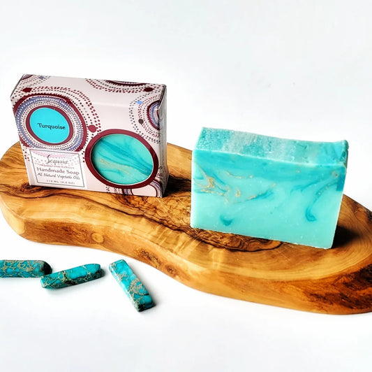 Turquoise soap bar with packaging on a wooden tray