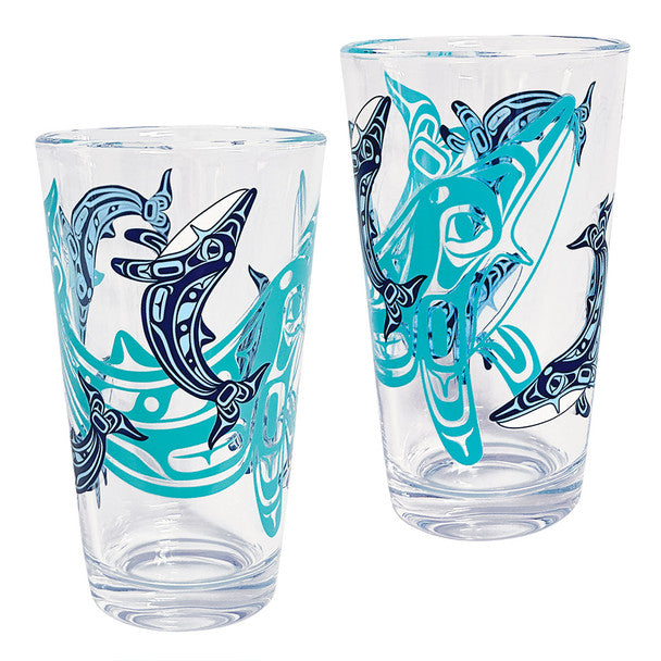 Two clear glasses with blue and black shark designs on a white background