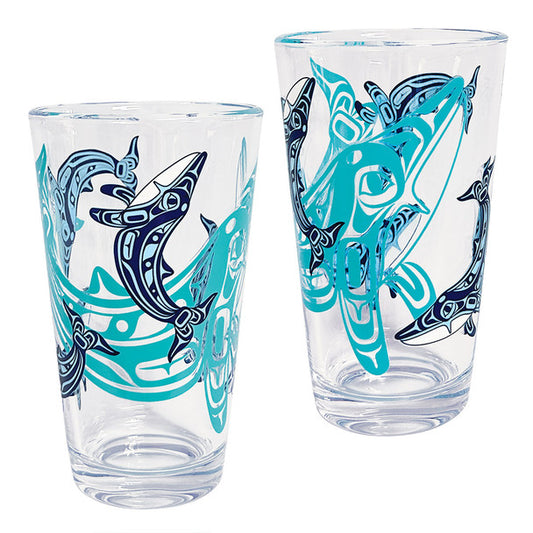 Two clear glasses with blue and black shark designs on a white background